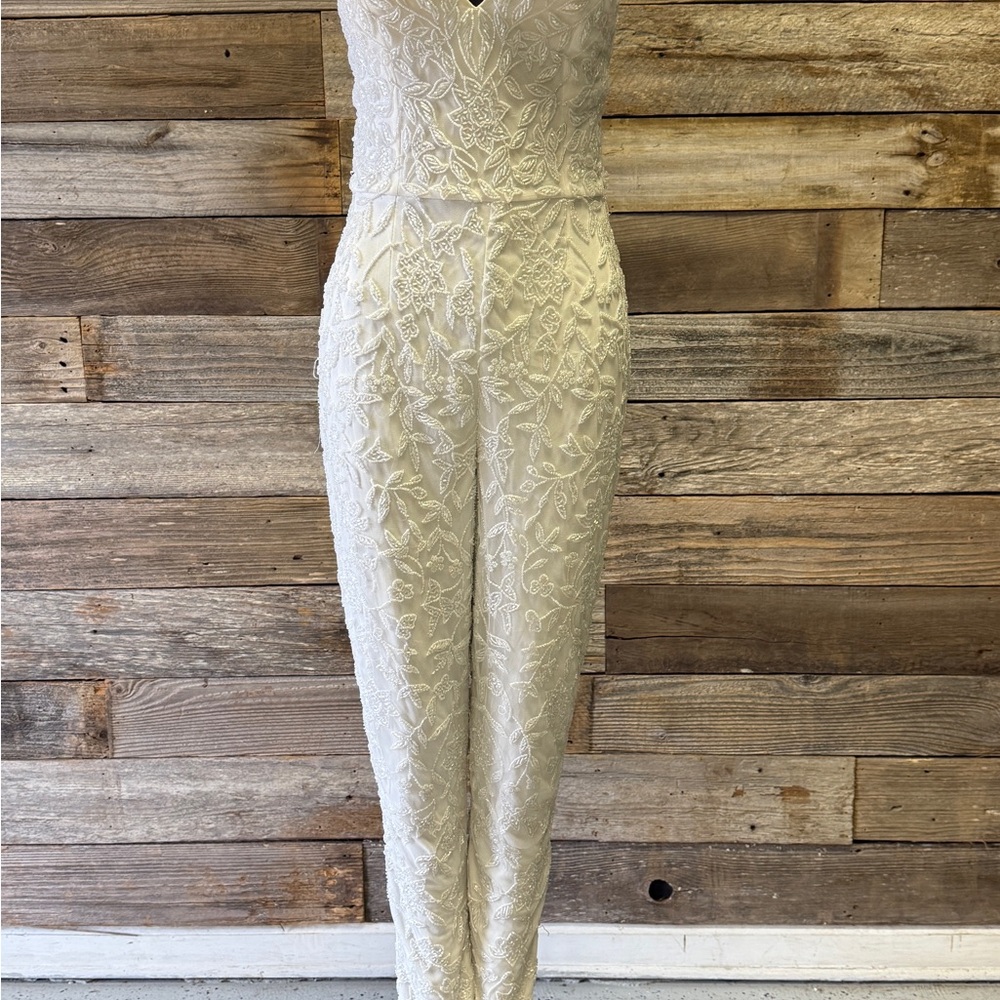 Primavera Couture White Lace Jumpsuit with Plunging Neckline